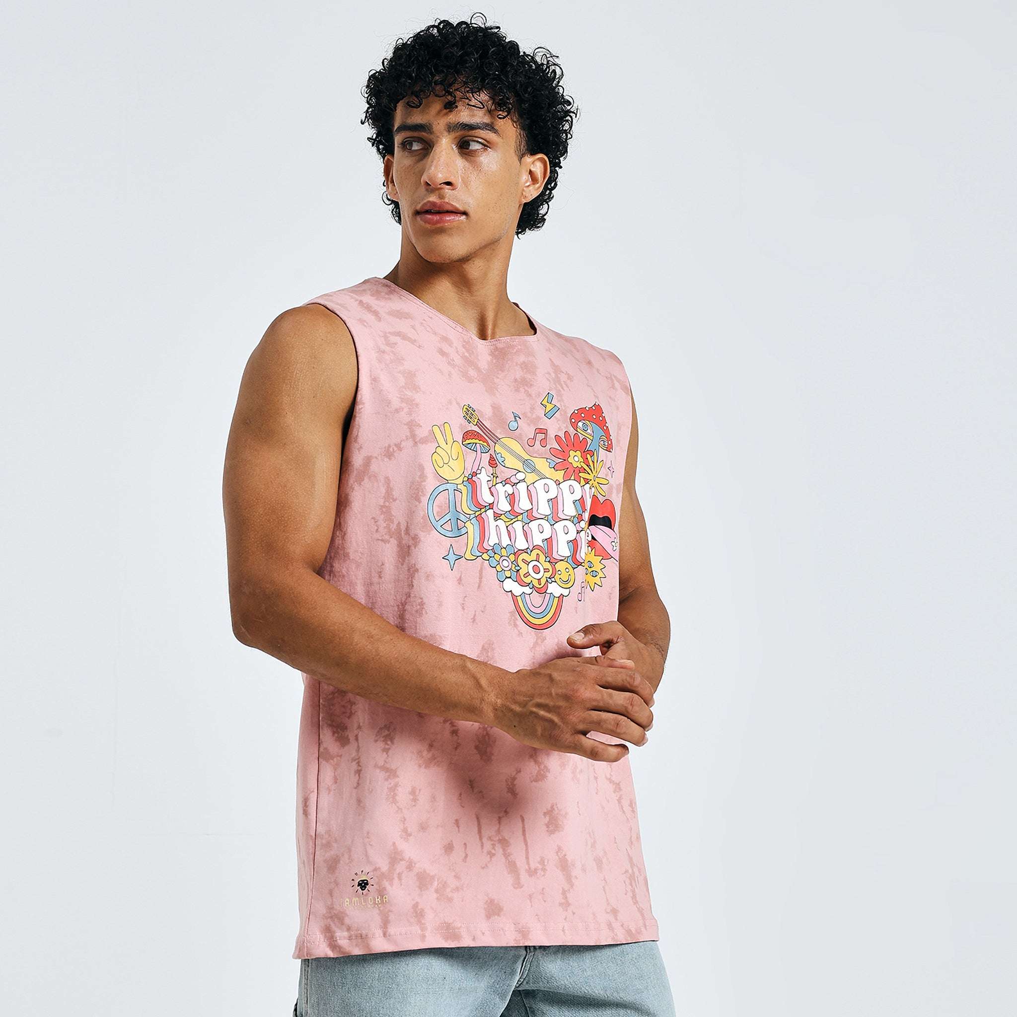 Side angle of model in pink sleeveless “Trippy Hippie” t-shirt
