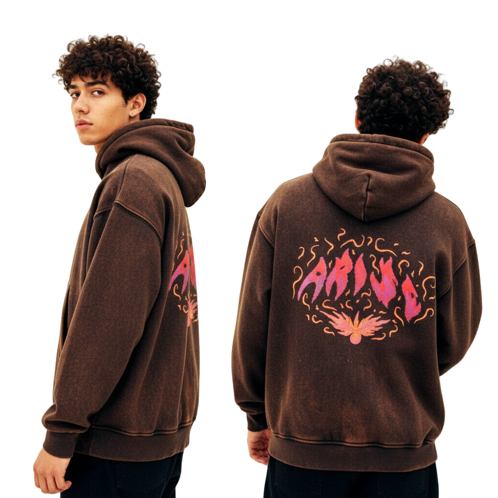 Brown hoodie with pink and orange design on the back, worn by a person against a plain background.