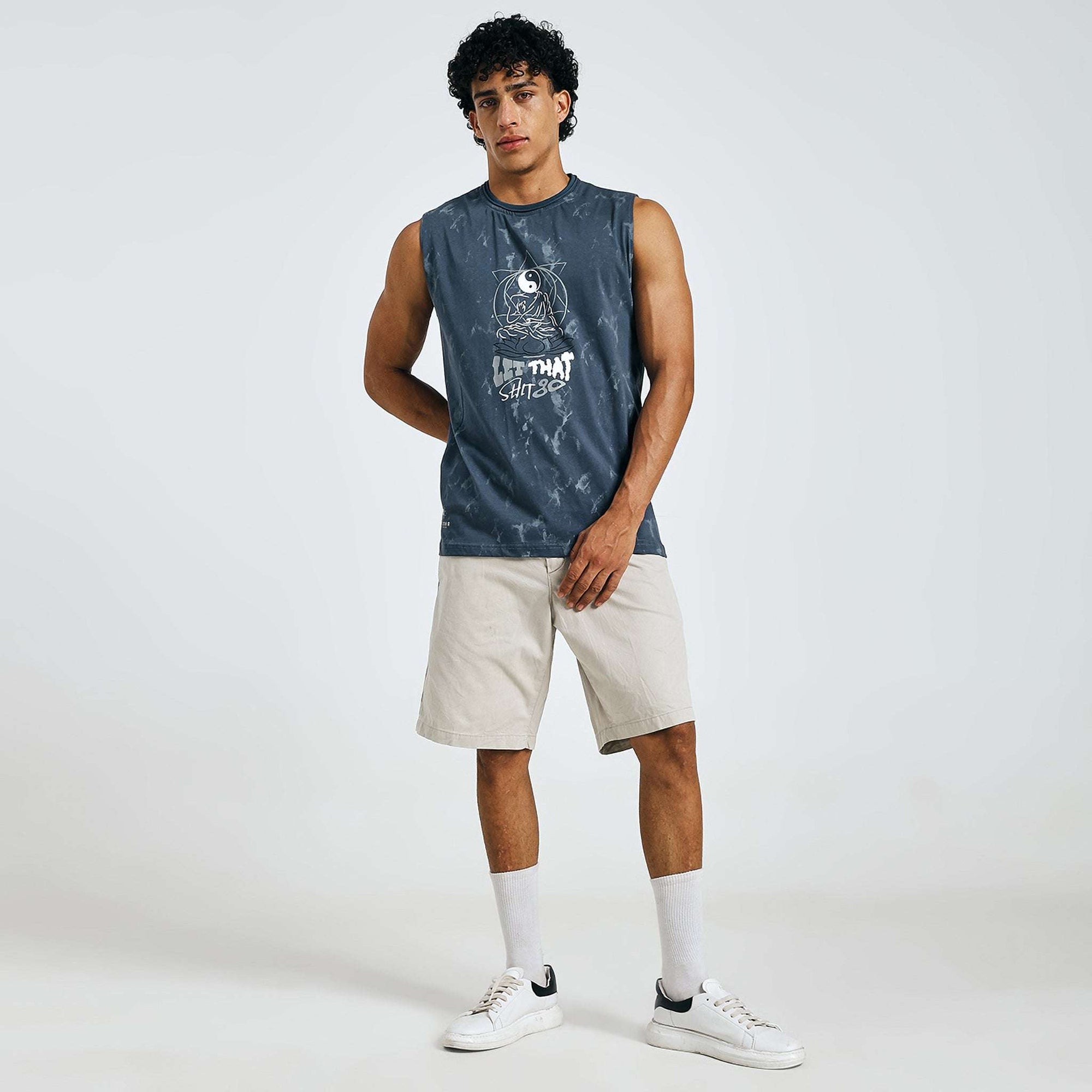 Dark blue tie-dye Yin-Yang tank with meditating figure print, "LET THAT SHIT GO" text, and raw edges on 240 GSM cotton sinker fabric.