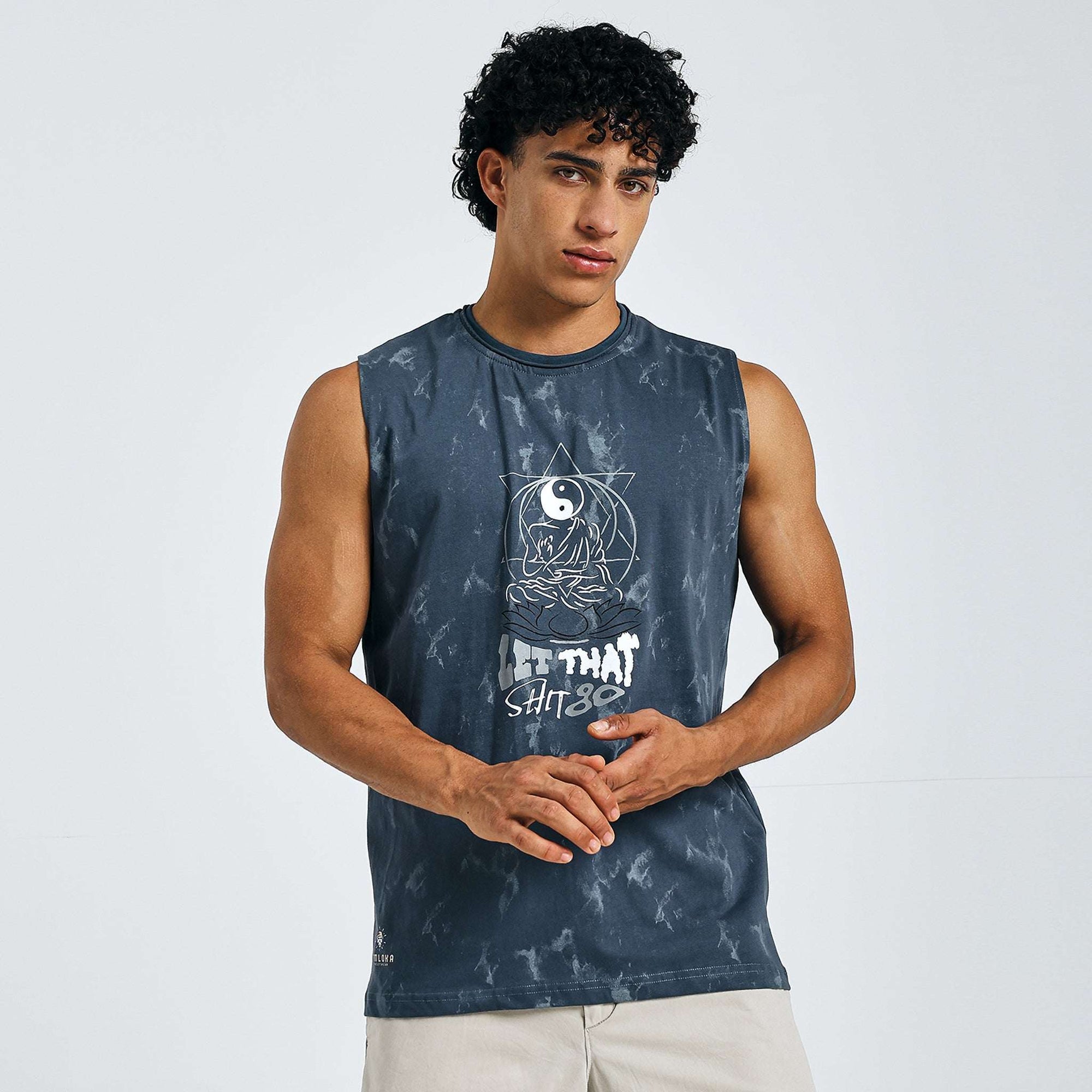 Man wearing Yin-Yang Tank with meditating figure and "LET THAT SHIT GO" text on dark blue tie-dye.