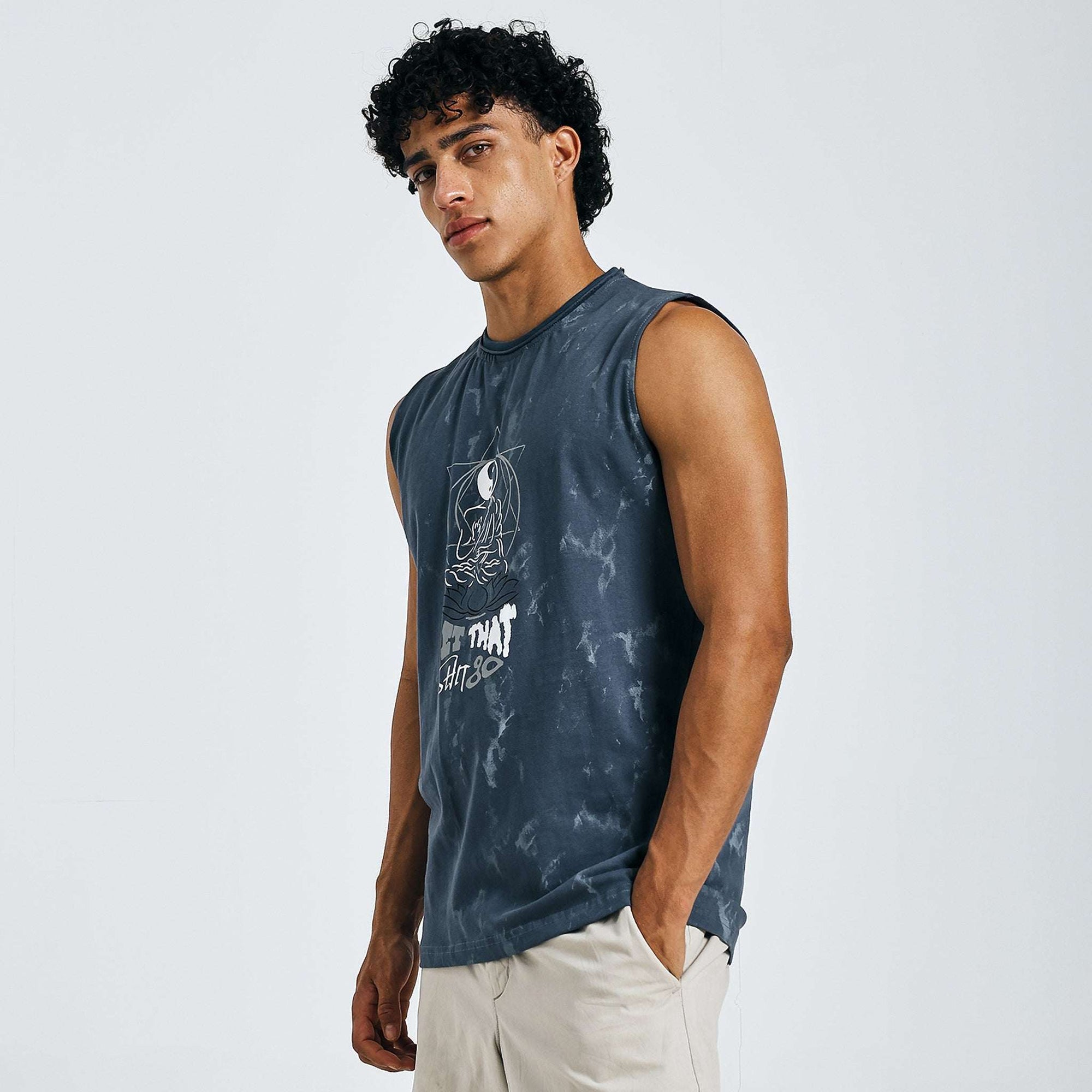 Dark blue tie-dye Yin-Yang tank with meditating figure print, "LET THAT SHIT GO" text, and raw edges on 240 GSM cotton sinker fabric.