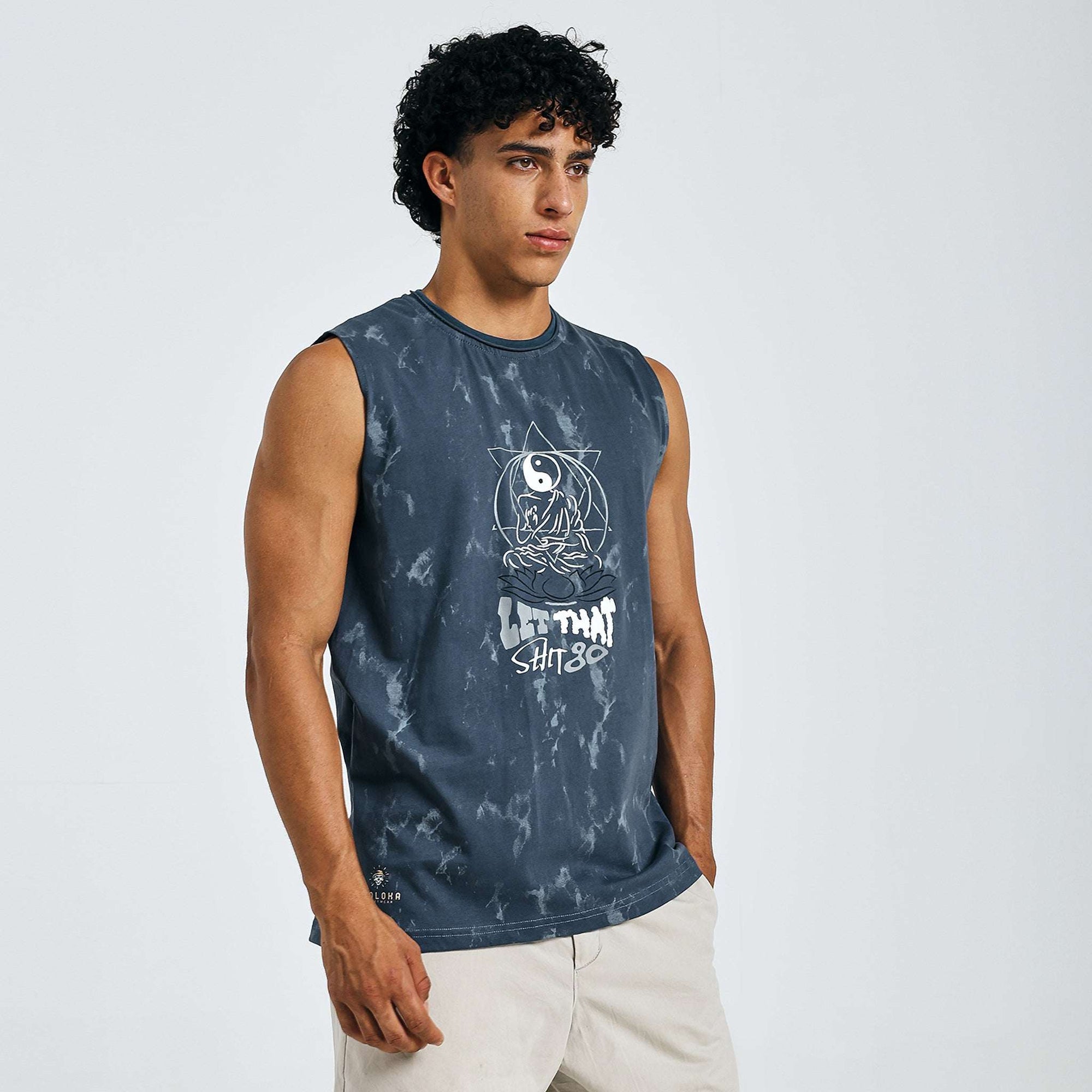 Dark blue tie-dye Yin-Yang tank with meditating figure print, "LET THAT SHIT GO" text, and raw edges on 240 GSM cotton sinker fabric.