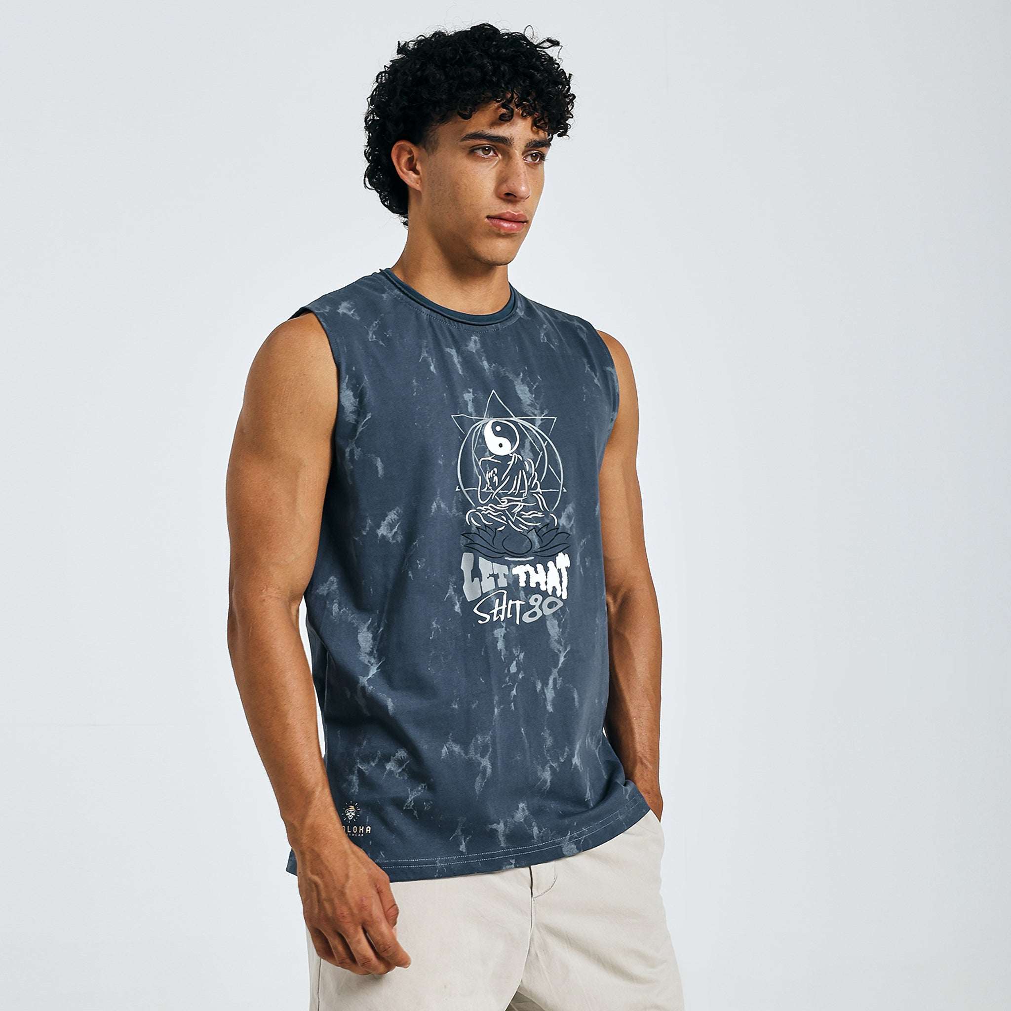 Dark blue tie-dye Yin-Yang tank with meditating figure print, "LET THAT SHIT GO" text, and raw edges on 240 GSM cotton sinker fabric.