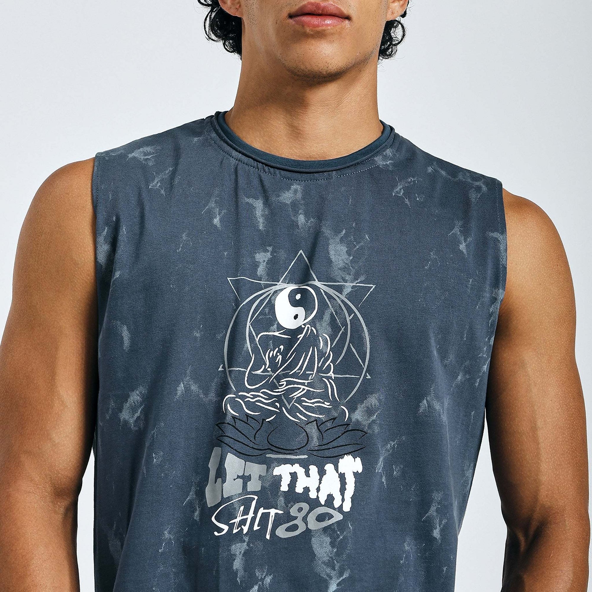 Dark blue tie-dye Yin-Yang tank with meditating figure print, "LET THAT SHIT GO" text, and raw edges on 240 GSM cotton sinker fabric.