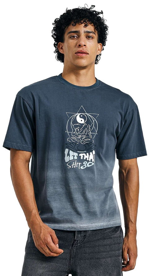 Person wearing a blue t-shirt with a graphic design on a plain background