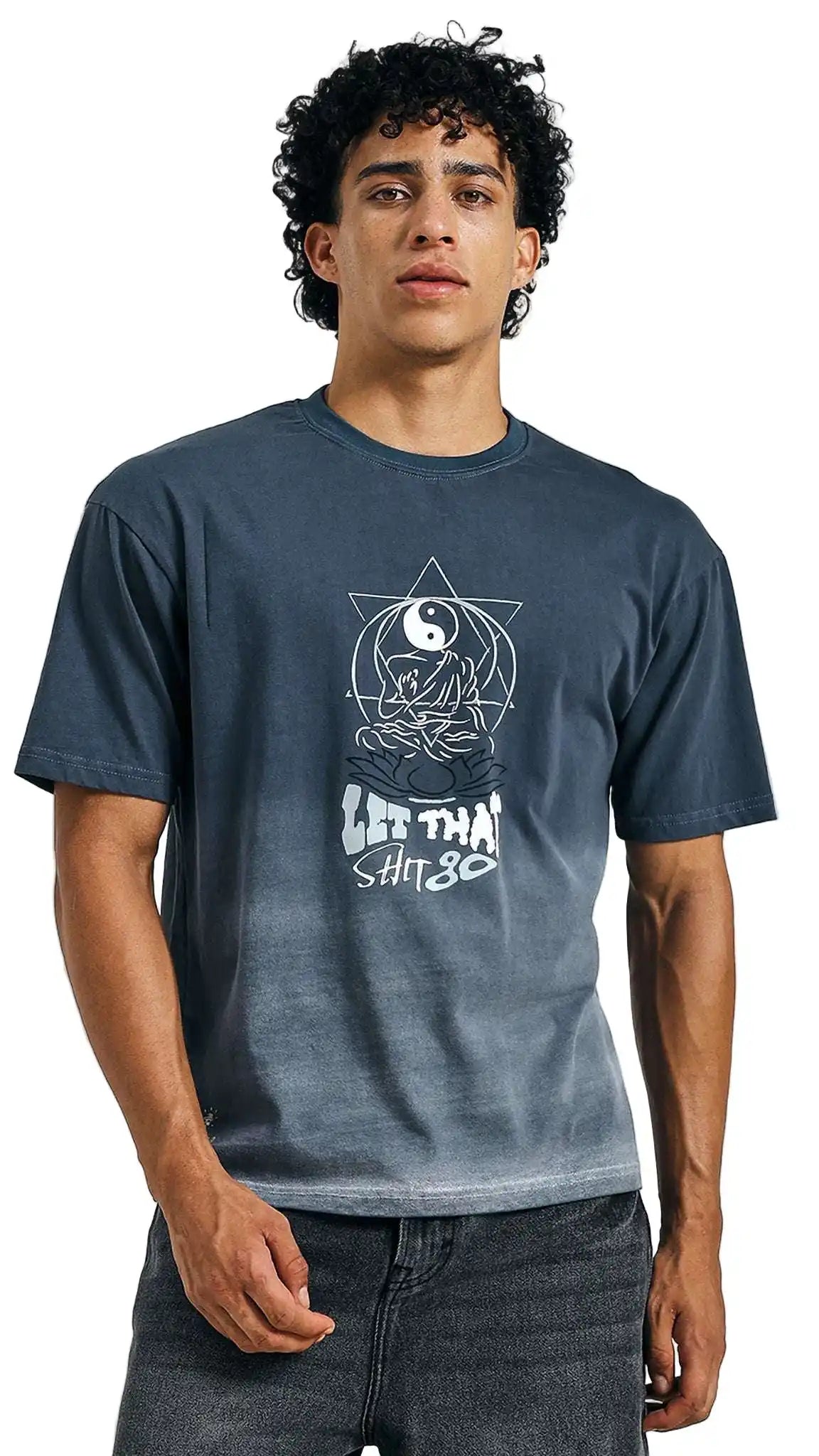 Person wearing a blue t-shirt with a graphic design on a plain background