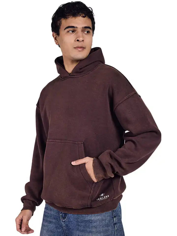 Man wearing a acid wash brown hoodie on a white background