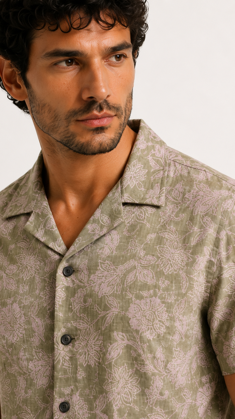 Man wearing a patterned shirt against a plain background