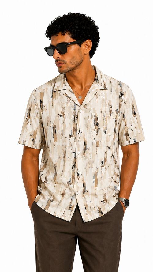 Man wearing a patterned shirt and sunglasses on a white background