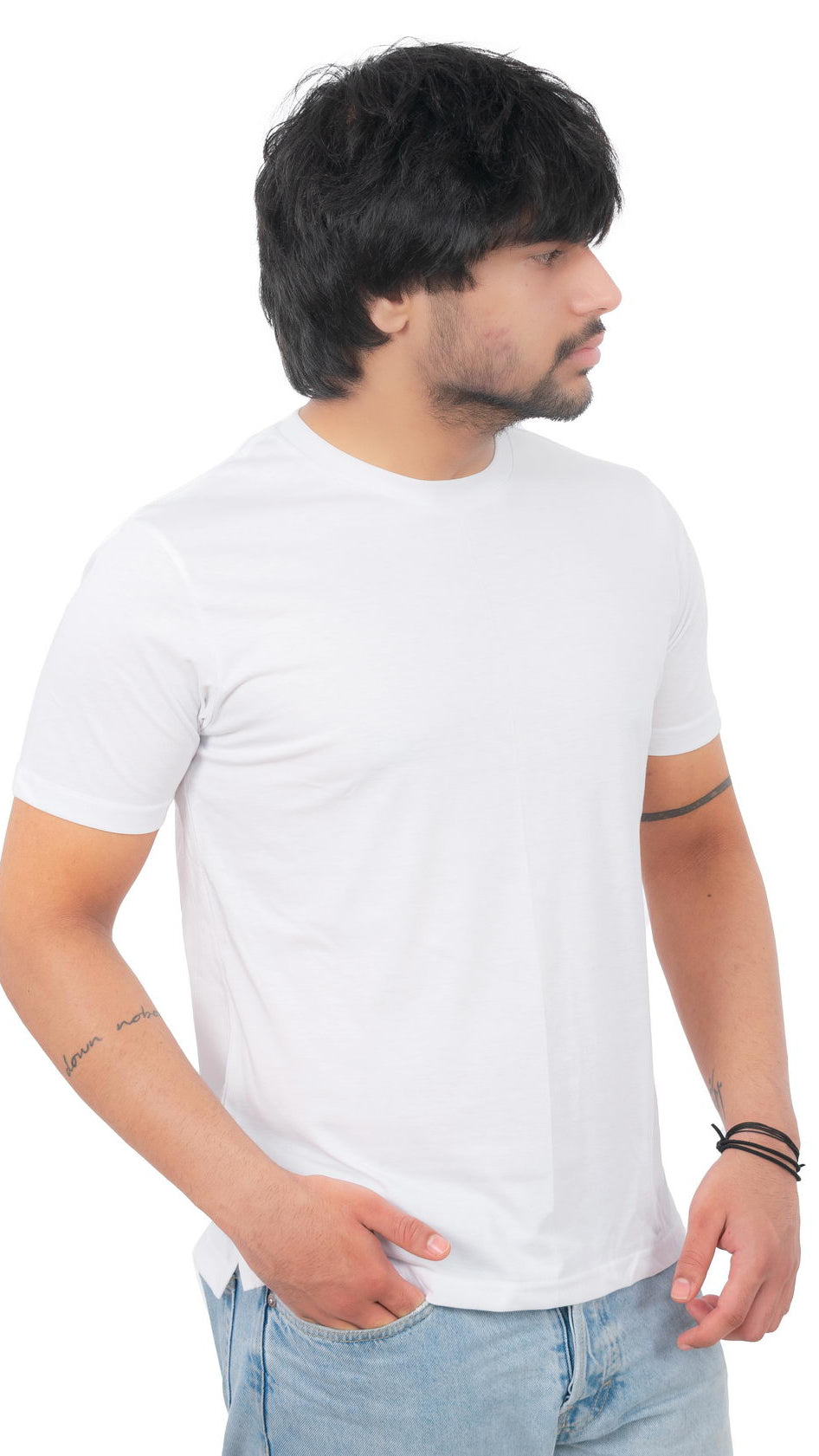 Man wearing a plain white t-shirt and light blue jeans on a white background