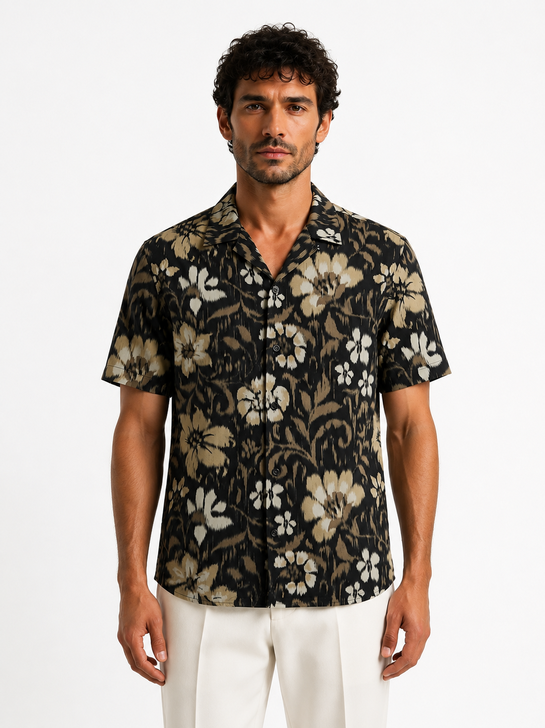 Man wearing a black floral patterned shirt on a white background
