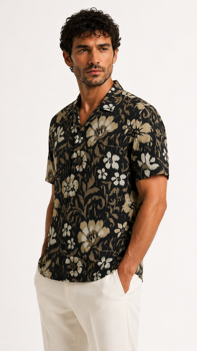 Man wearing a black floral patterned shirt on a white background