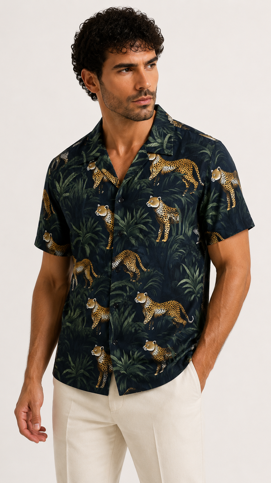 Man wearing a dark shirt with animal print on a white background