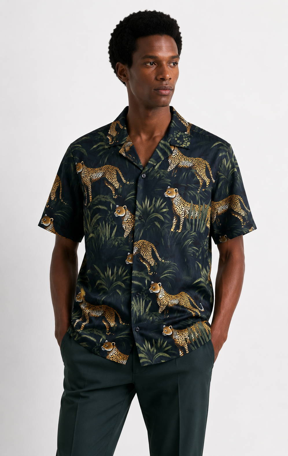 Man wearing a dark shirt with animal print on a white background