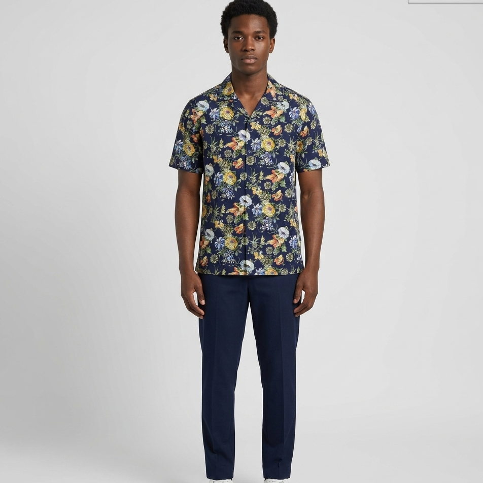 Man wearing a floral shirt and navy pants on a white background
