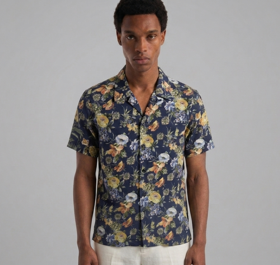Man wearing a floral short-sleeve shirt against a gray background