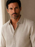Man wearing a beige linen shirt against a neutral background