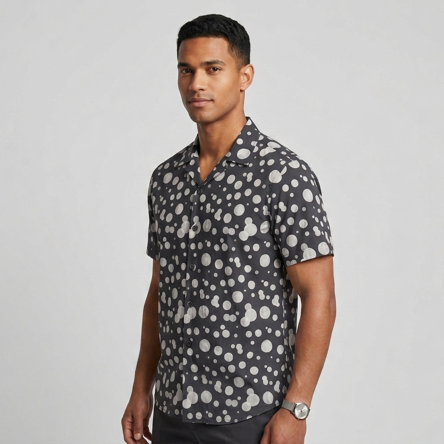 Man wearing a patterned shirt against a plain background