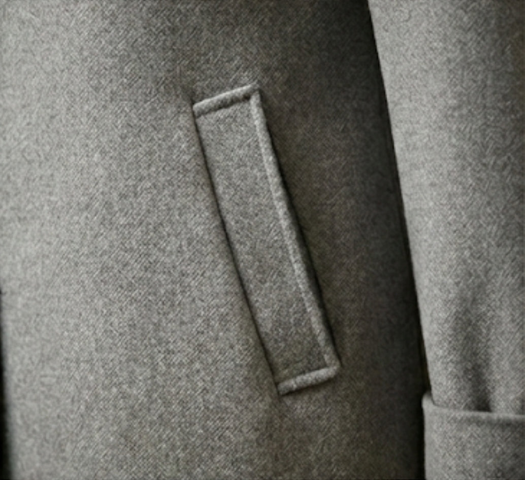 Close-up of a gray coat with a button detail