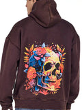 A hoodie with a flowery skull print on the back, in a rust color.
