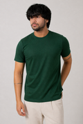 Man wearing a green t-shirt against a plain background