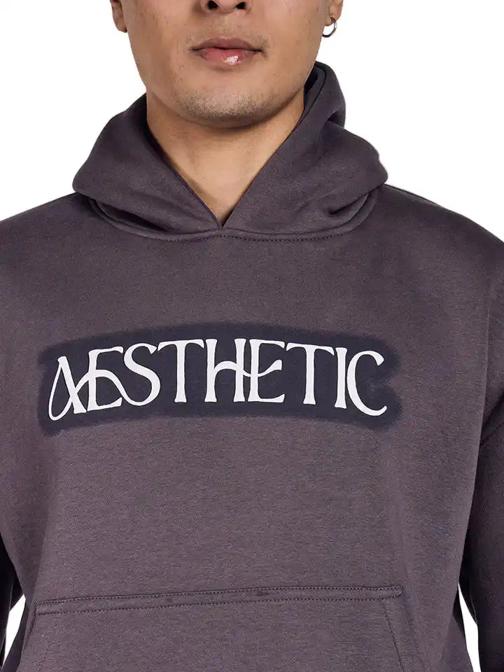 A dark grey oversized hoodie with aesthetic art screen printed on the front and back.