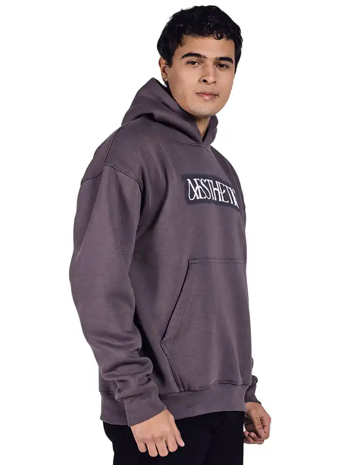 A dark grey oversized hoodie with aesthetic art screen printed on the front and back.
