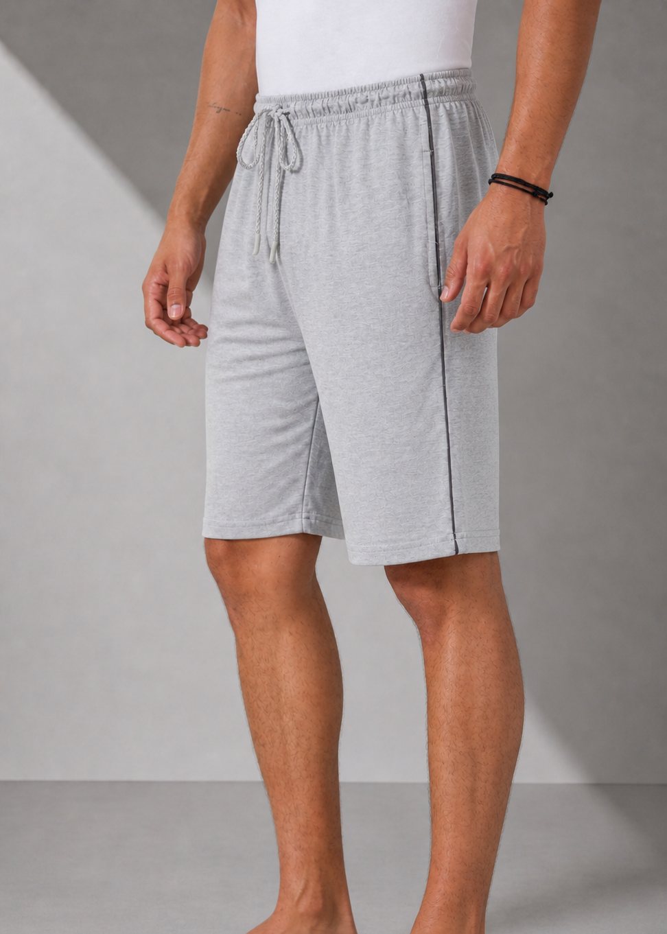 Person wearing gray shorts on a plain background