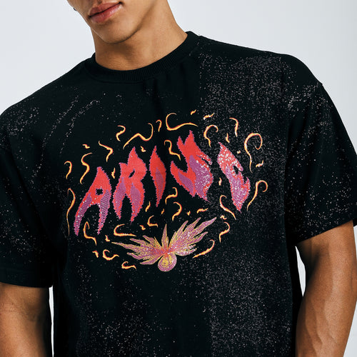 Close-up of black Arise graphic tee with fiery psychedelic design on chest