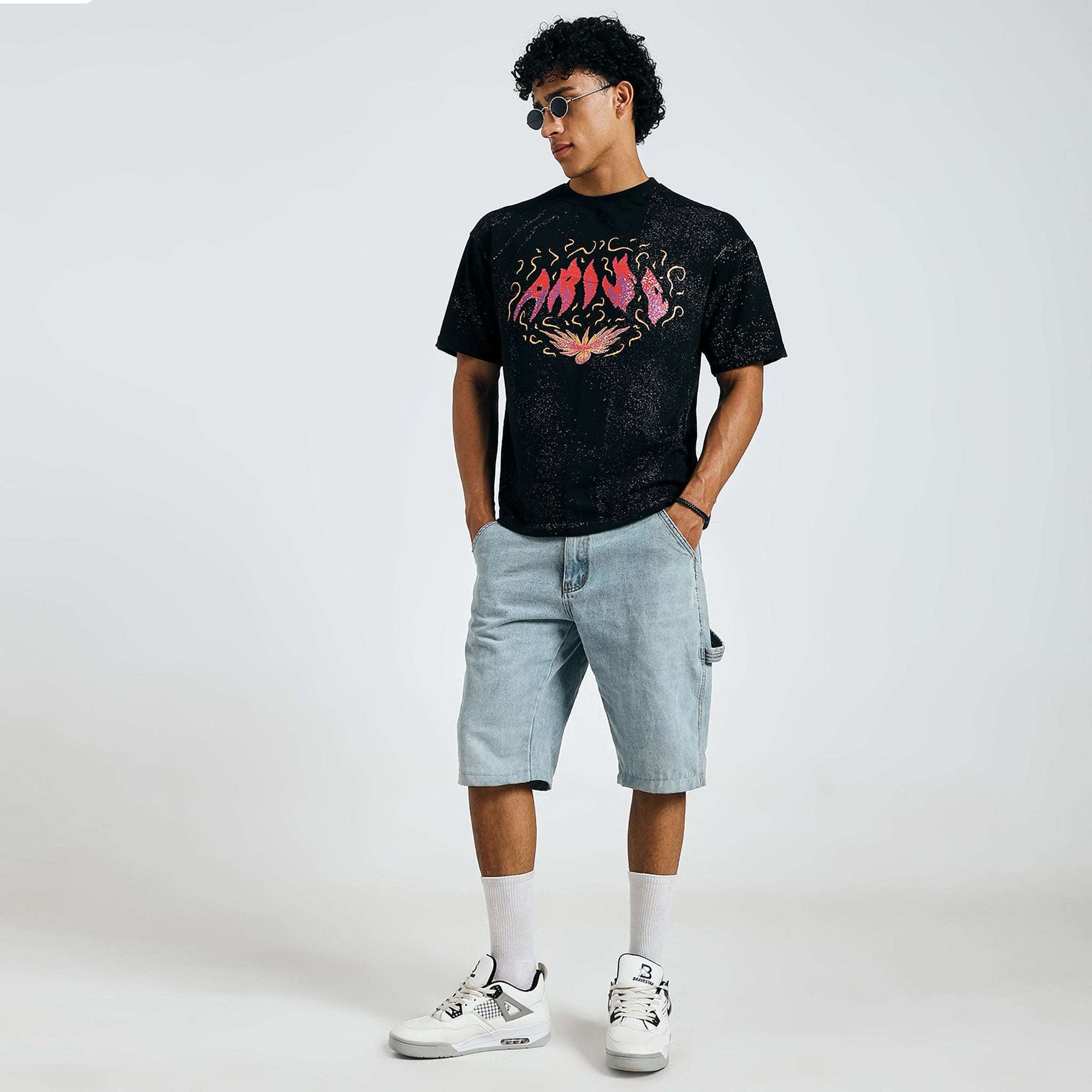 Buy black Arise graphic tee, fashion pose with sunglasses, on model.