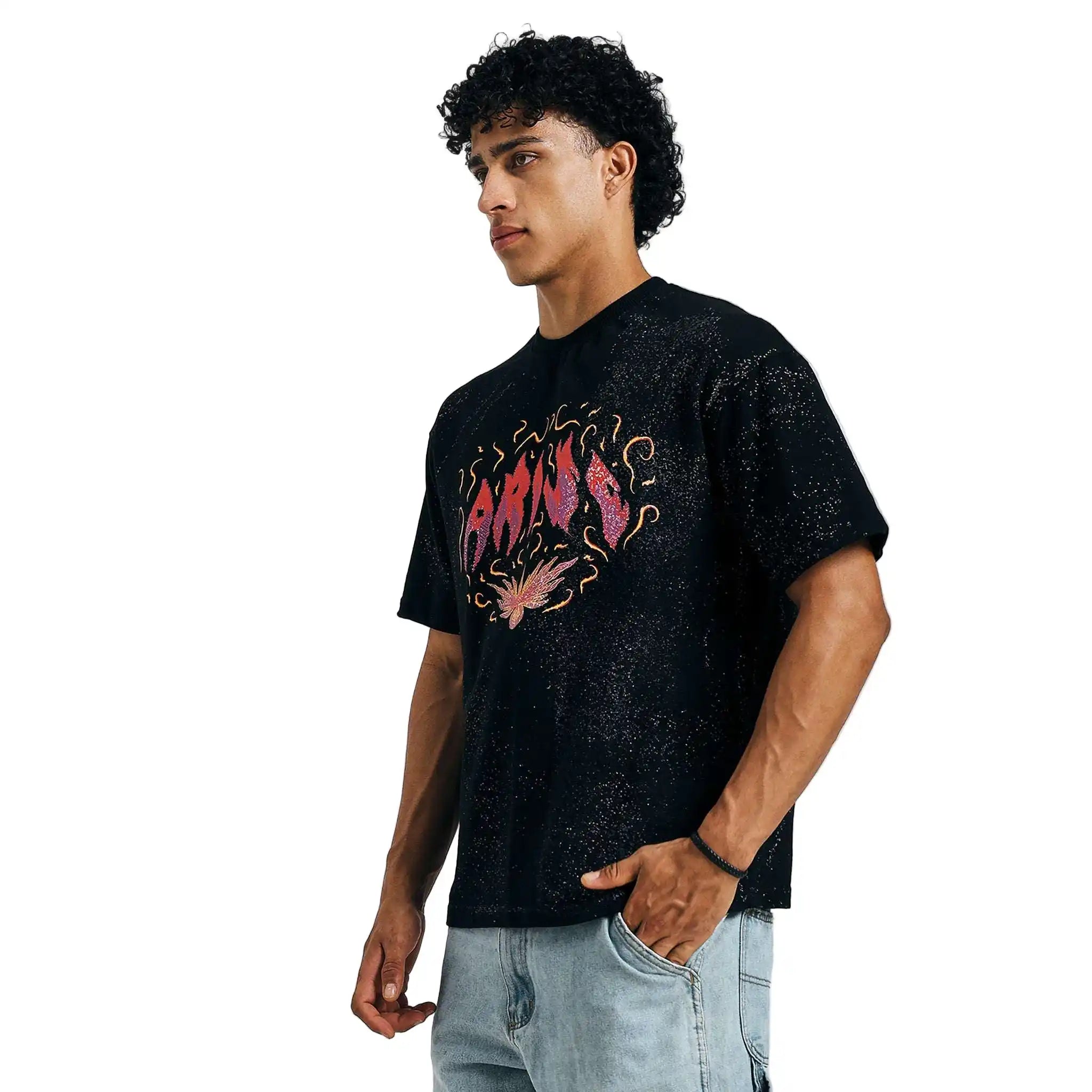 Black Arise graphic tee, side view, on model with hands in pockets