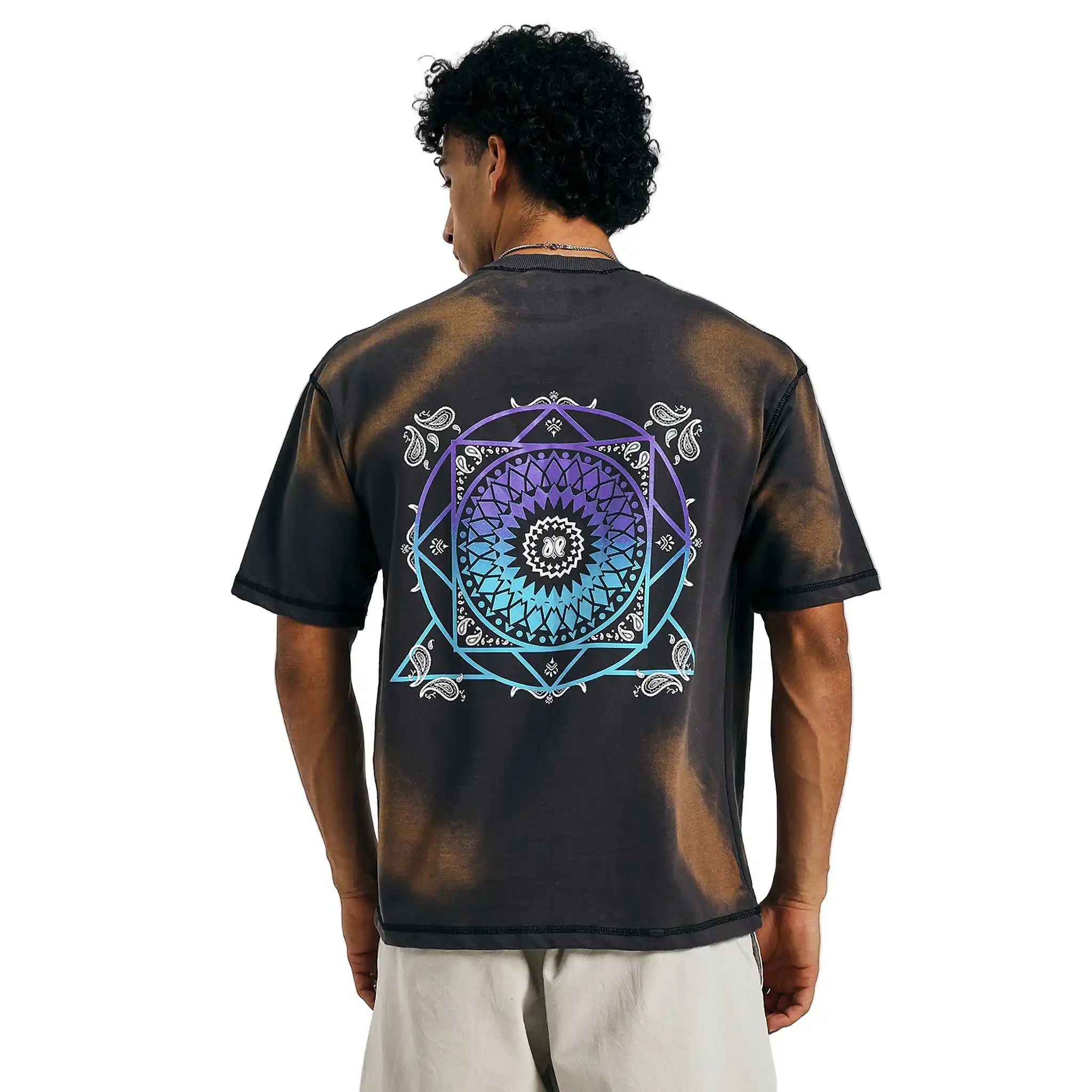 Buy black tie-dye tee with colorful mandala design, back view, paired with beige shorts.