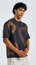 Buy black tie-dye mandala tee, front view, hands clasped, with beige shorts on model.