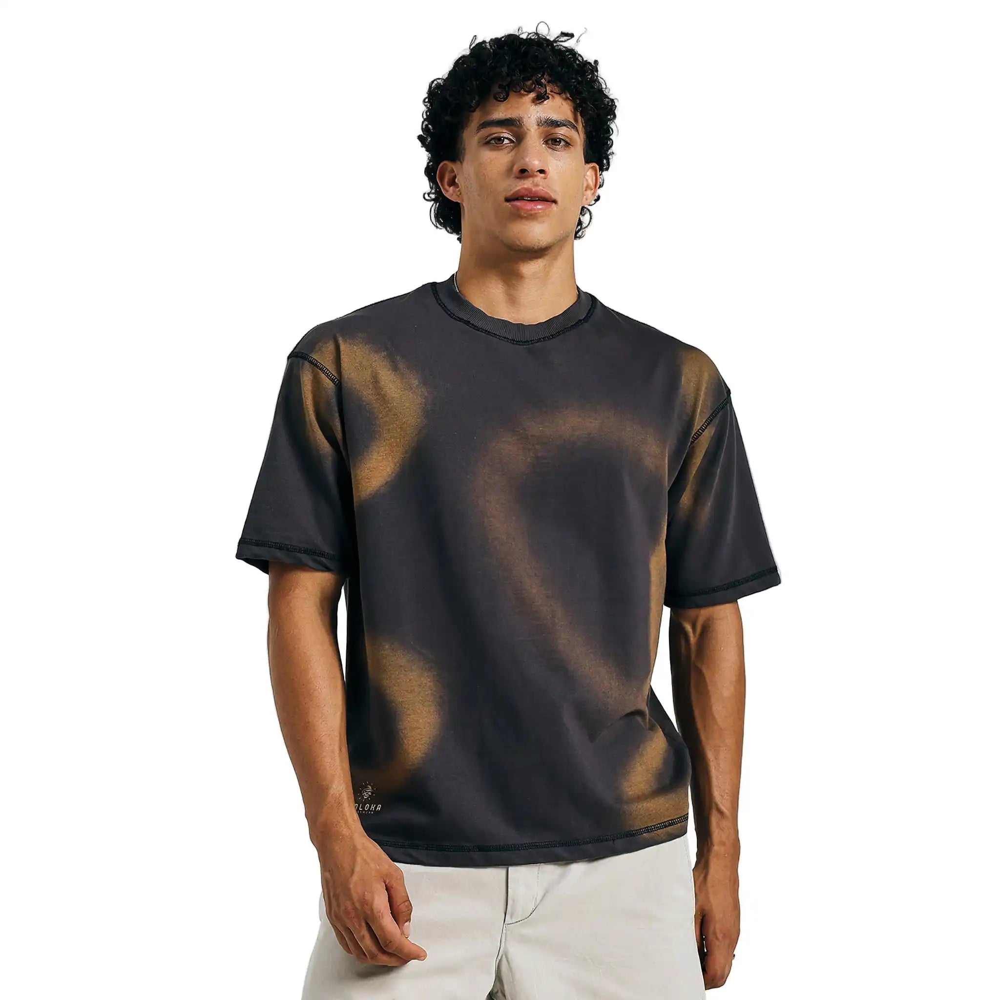 Black tie-dye mandala tee in urban casual style, walking in daylight with beige shorts.