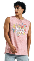 Front view of man wearing pink sleeveless “Trippy Hippie” graphic t-shirt with light denim shorts