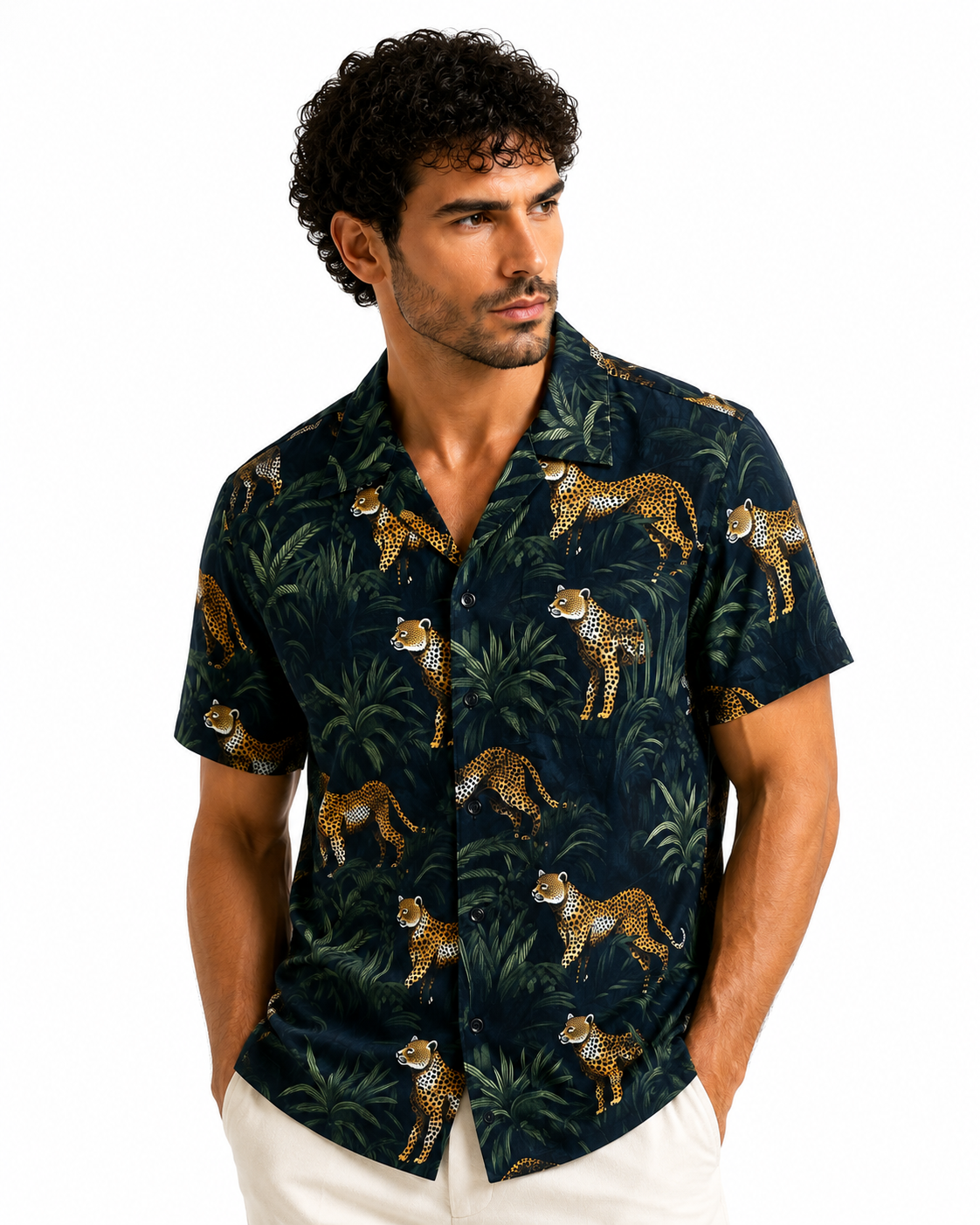 Man wearing a dark patterned shirt with animal designs on a white background