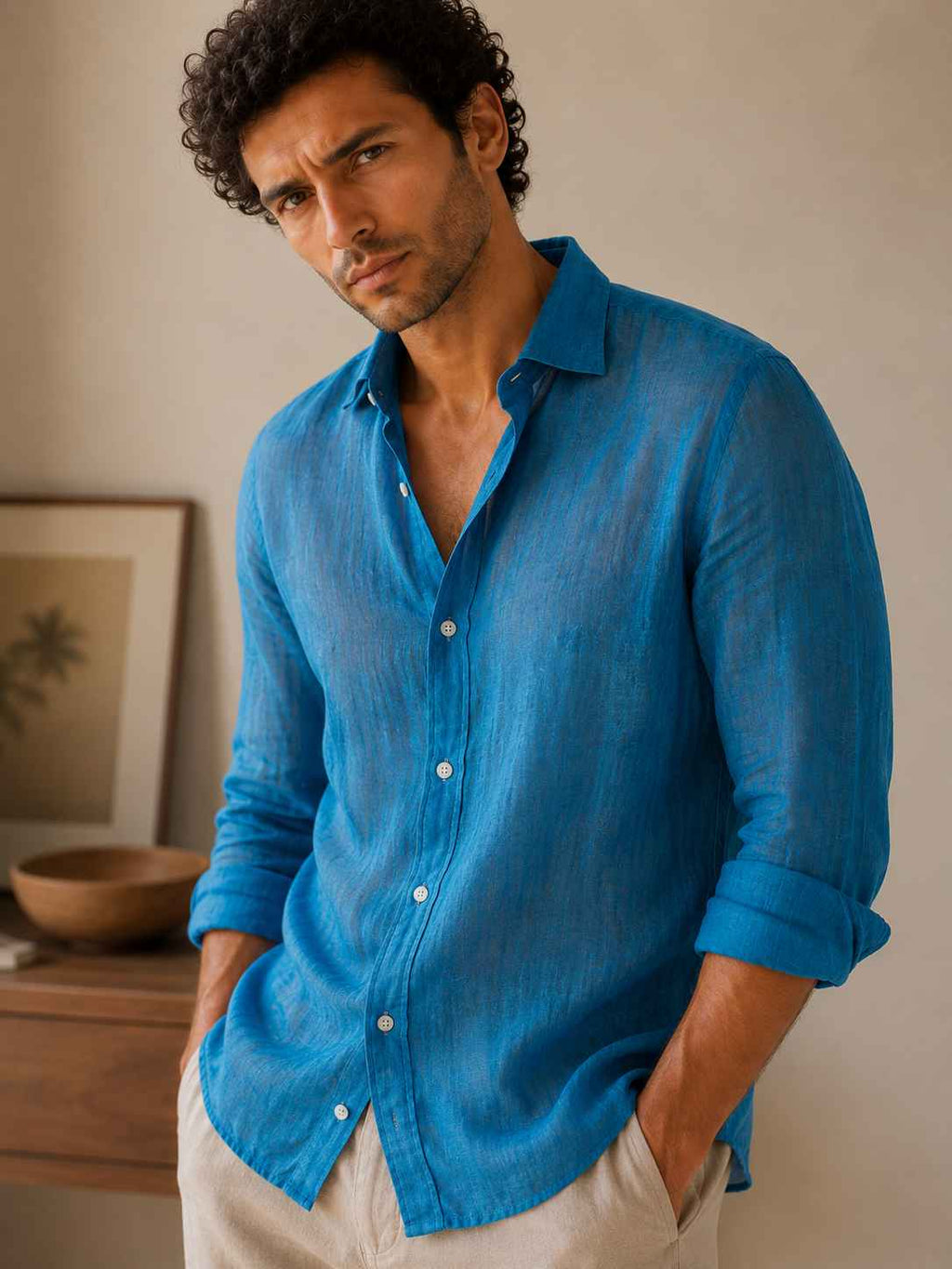 Man wearing a blue shirt with a neutral background