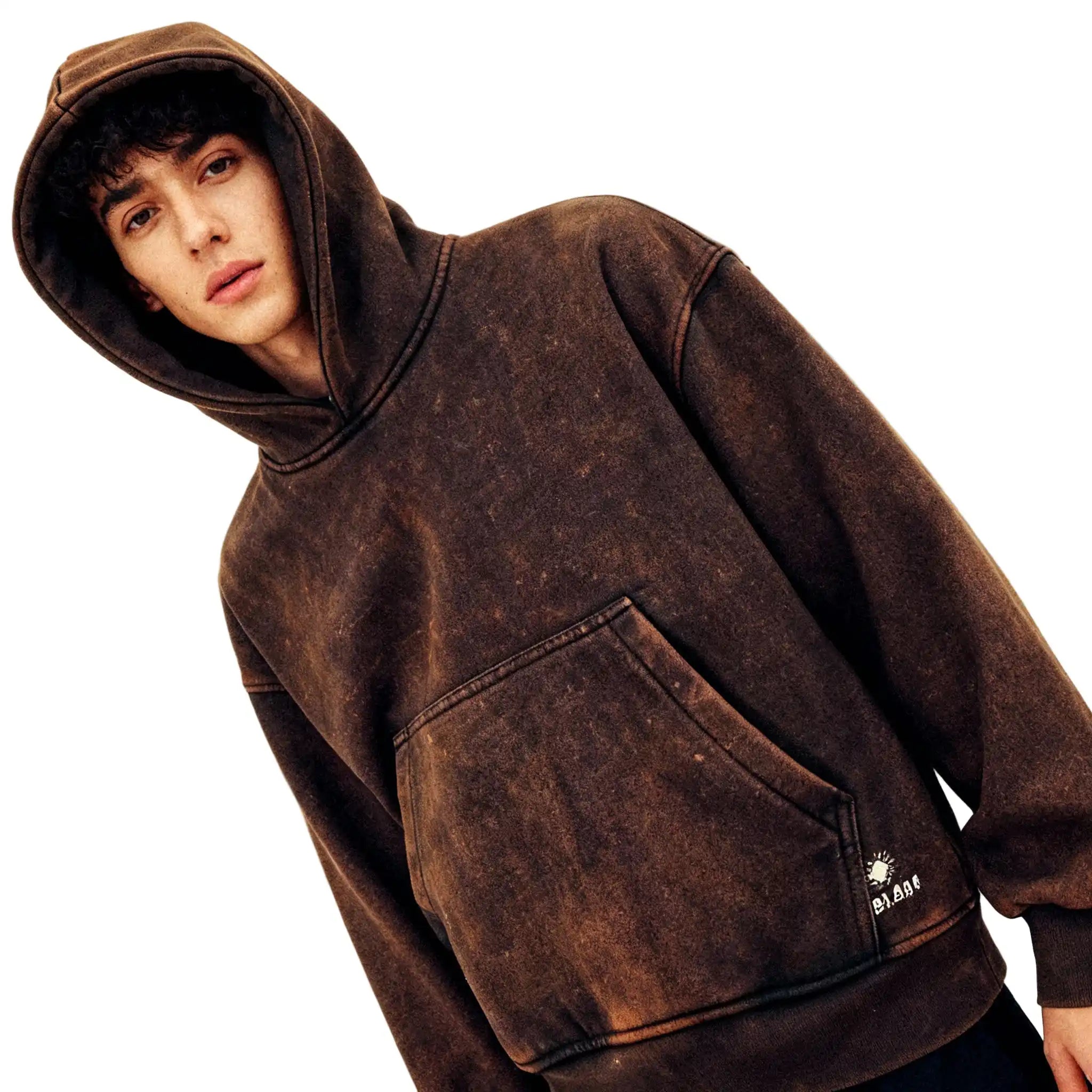 Person wearing a brown hooded sweatshirt on a plain background
